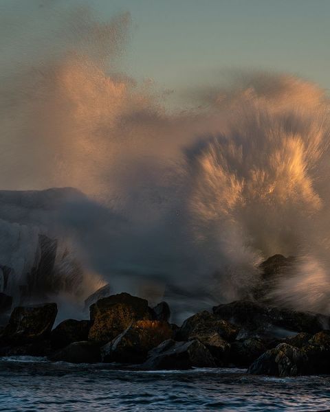Minnesota-Lake Superior Lake waves breaking on rocks at sunset